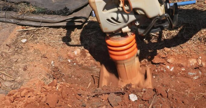 Tamping machine compactor tool vibratory plate jumping at compacting to ground in under construction