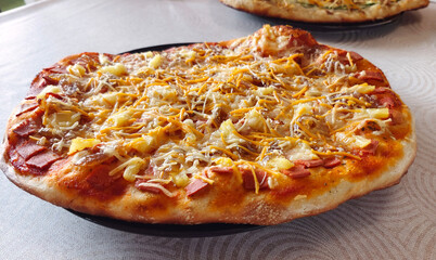 Tasty Hawaiian vegan pizza on a plate. Front view