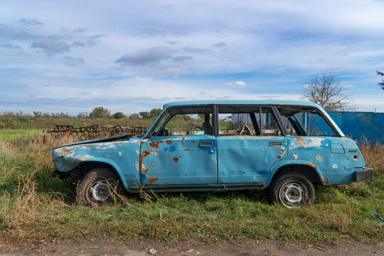 War in Ukraine. 2022 Russian invasion of Ukraine. Countryside. A destroyed civilian car stands on the side of the road. Holes from bullets and splinters on the body of the car