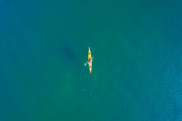 Red or yellow kayak with man sea, open space, aerial top view