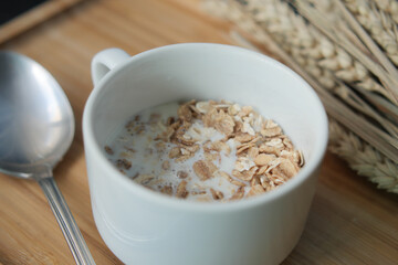granola musli and milk in a cup on table 