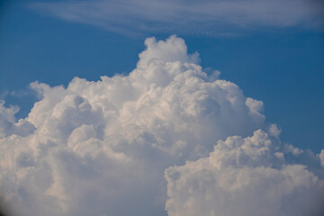 White fluffy clouds in the blue sky background