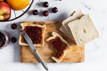 Delicious toasts with jam on cutting board