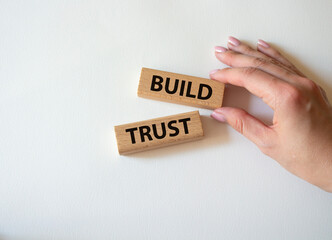 Build trust symbol. Wooden blocks with words Build trust. Beautiful white background. Businessman...