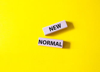 New normal symbol. Wooden blocks with words New normal. Beautiful yellow background. Business and New normal concept. Copy space.