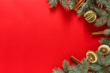 Christmas red background from green fir branches, frame, top view	