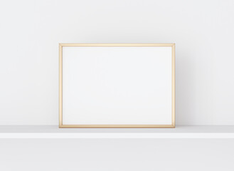 Interior poster mockup with horizontal golden metal frame on white wall. A4, A3 size format. 3D rendering, illustration.