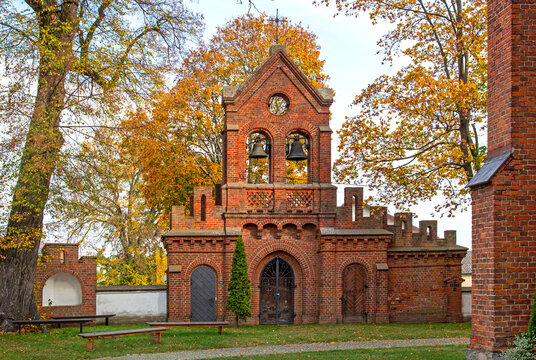 General view and architectural details of the brick belfry built in 1875 and the Catholic Church of the Immaculate Conception of the Blessed Virgin Mary in Ceranów in Mazovia, Poland.