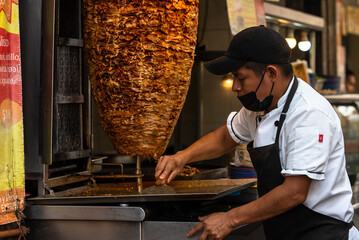 Mexican taquero working doing tacos	
