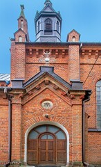 General view and architectural details of the brick belfry built in 1875 and the Catholic Church of the Immaculate Conception of the Blessed Virgin Mary in Ceranów in Mazovia, Poland.