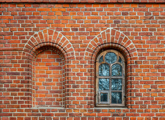 General view and architectural details of the brick belfry built in 1875 and the Catholic Church of the Immaculate Conception of the Blessed Virgin Mary in Ceranów in Mazovia, Poland.