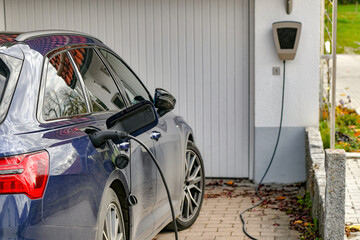 An electric car is charged from a gas station in a private house.