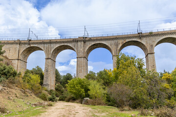 Fototapeta na wymiar railway bridge that crosses the cofio river in the Sierra de Guadarrama, Madrid