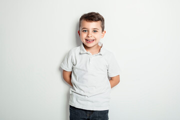 five year old boy posing over white studio background