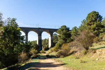 Fototapeta na wymiar railway bridge that crosses the cofio river in the Sierra de Guadarrama, Madrid