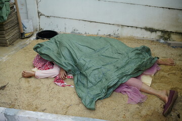 Dead woman lay down under bag covered death body from accident or murder at house of victim with...