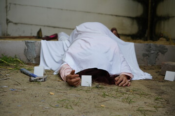 Dead woman lay down under bag covered death body from accident or murder at house of victim with...