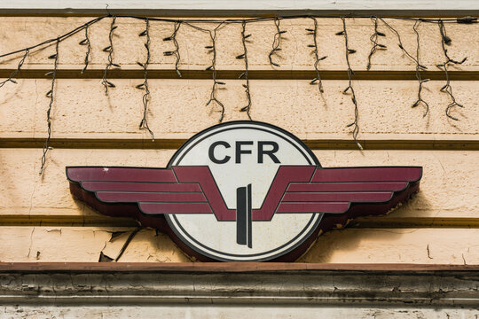 Cluj-Napoca, Romania - JUN 14, 2021: CFR Calatori railway or railroad company logo on the exterior of a train station building