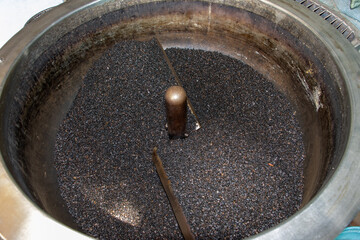 A seeds of the black cumin in the rotating roaster.