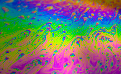 Fototapeta na wymiar Photo of iridescent surface of soapy water. Space, halographic, psychedelic background for screensaver.