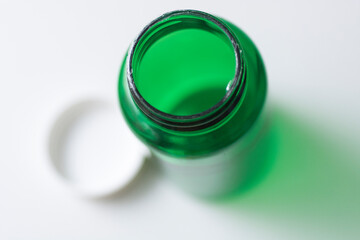Green plactic bottle of pills
