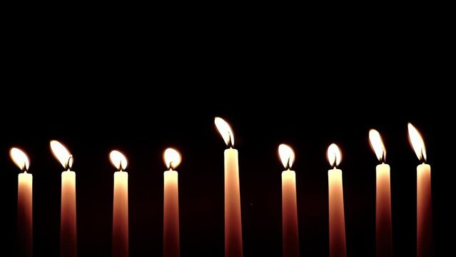 Hanukkah candles. Traditional candelabrum with burning candles on black background