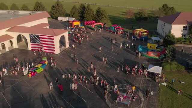 Aerial drone footage of people walking around the Solid Rock Church at sunset in Monroe, Ohio