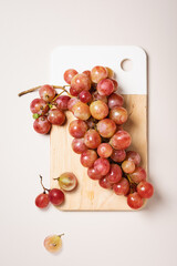 Red grapes on wooden board