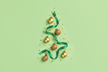Christmas card with golden glitter balls decorations and satin ribbon on green background