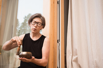 asian woman with sound bowl