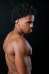 Fototapeta premium Young strong sportsman. Latin athlete portrait. Black background.