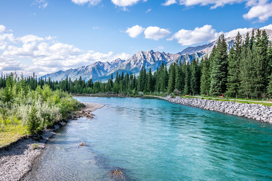 A beautiful photo of river in Canmore, Alberta with the rocky mountains in the background. 