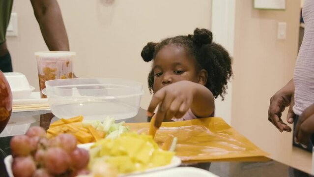 Young Black children, Black girls, Black boy, Black infant baby, Black parents, Black mother, and Black father cooking and eating lunch and dinner at home
