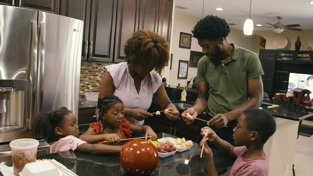 Young Black children, Black girls, Black boy, Black infant baby, Black parents, Black mother, and Black father cooking and eating lunch and dinner at home