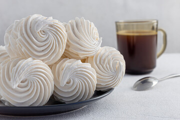 delicious zephyr on a plate standing on a light marble background. homemade desserts, pastry shop, pastry chef, holiday, birthday, valentine's day, confectionery products, tea party concept