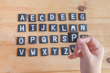 Hand hold a English alphabet letters .