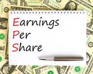 EPS earnings per share symbol. Concept words EPS earnings per share on white note on a beautiful background from dollar bills. Businessman hand. Business and EPS earnings per share concept. Copy space