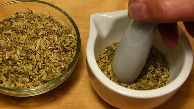 grinding fennel seeds in a mortar with sound