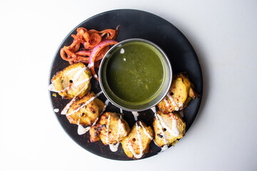 Spicy bbq Chicken Reshmi tikka boti Kebab with chili sauce served in a dish isolated on grey background top view of bangladesh food