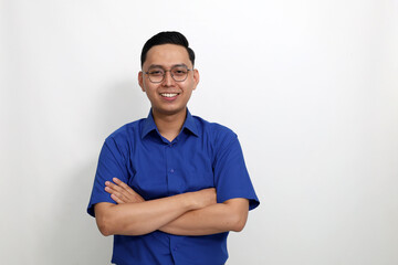 Happy young asian man standing with folded hand. Isolated on white background