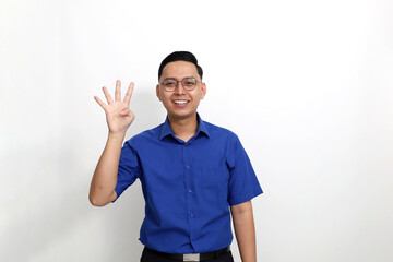 Fototapeta premium Happy young asian man standing while showing four fingers. Isolated on white background