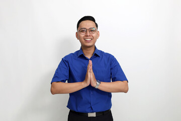 Fototapeta premium Handsome young asian man standing with welcoming hand gesture. Isolated on white background