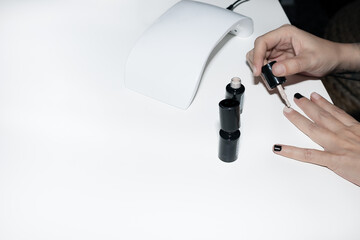 Woman painting her nails at home