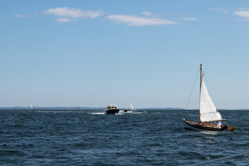 Sailboat and motorboat in the ocean