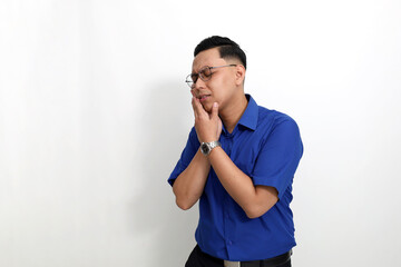Young asian man standing while suffering from toothache. Isolated on white background with copyspace