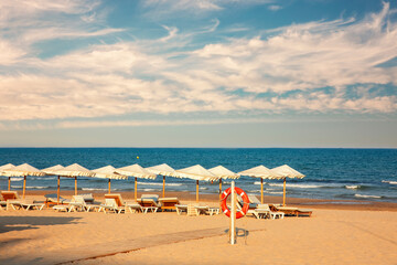 Fototapeta na wymiar serenity sunset beach with clouds on the blue sky. Guardamar del Segura, Alicante. Spain