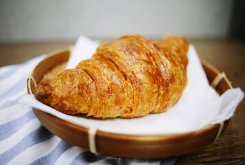 Croissant on woven plate