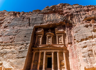 A view towards the Treasury building facade in the ancient city of Petra, Jordan in summertime