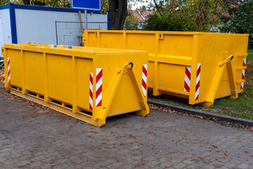Two yellow metal dumpster containers for construction garbage, house renovation, building of...