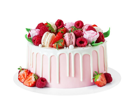Birthday sweet cake with berries, macaron and floral decor isolated on a white background.